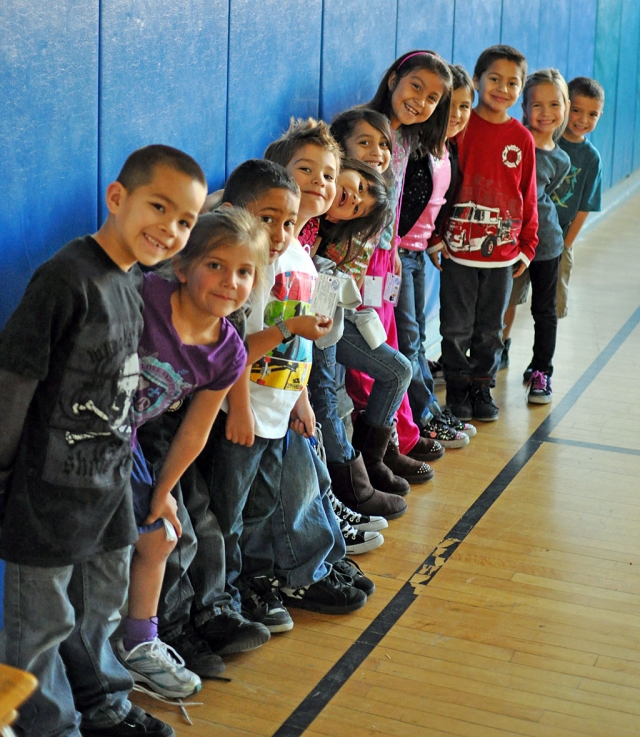 Kids lining up for a healthy snack after the routine club meeting. 