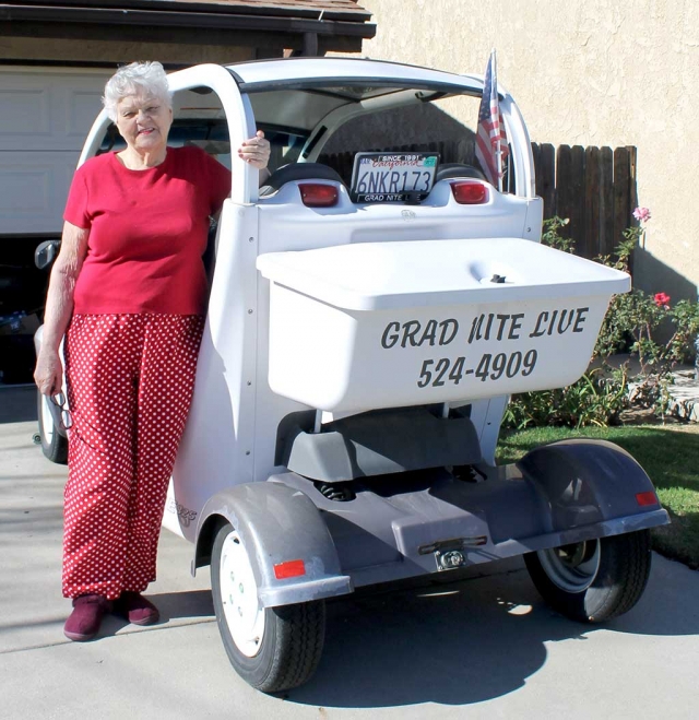 Mrs. Chaney standing next to the infamous Grad Nite Live Electric Car. Mrs. Chaney said, “It is with a heavy heart I am selling my electric car (Grad Nite Live). I can’t drive any more so it sits. It needs some TLC and batteries. I drove 10,000 miles since 2002 and never left Fillmore. It will be nice to see my GEM out and about in Fillmore again. Thanks for waving at me all those years.”