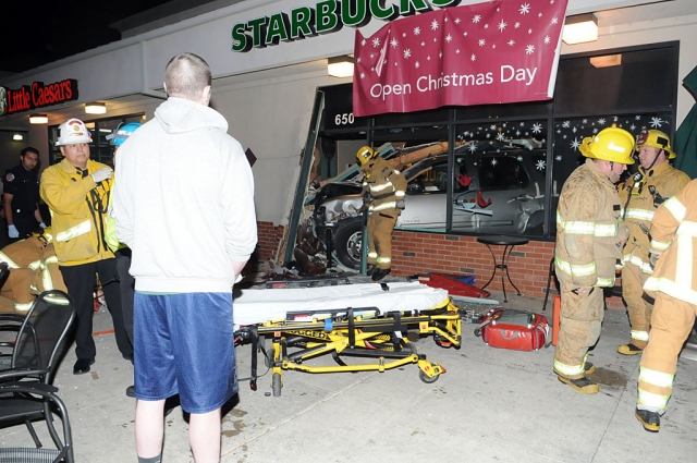 (Foreground wearing shorts) Michael Cedarland looks at his SUV inside Fillmore Starbucks.