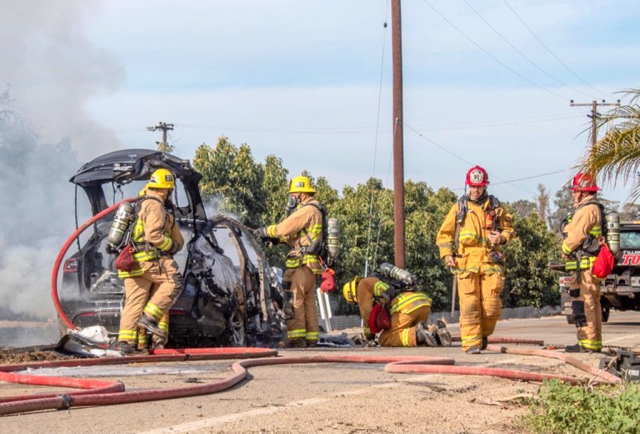 On Thursday, March 3, 2022, at 8:16am, Ventura County Fire Department, Fillmore City Fire, Ventura County Sheriff’s, California Highway Patrol and AMR Paramedics were dispatched to a reported solo vehicle in a ditch in the area of Riverside Avenue and Santa Paula St., Bardsdale. Arriving fire crews reported a vehicle in ditch, one occupant out of the vehicle-no injuries-with a fully engulfed Tesla, according to CHP. According to CHP the Tesla battery caught fire—vehicle was fully engulfed. VCFD PIO Twitter reported: “It took about 4 hours, 2,500 gallons of water, 5 engines, 1 water tender 2 BC’s and a Hazmat Officer to control the scene.” According to the onscene CHP Officer the Tesla was traveling eastbound on Riverside Avenue, lost control and caught fire. Sheriff ’s Deputies shut down eastbound and westbound lanes of Riverside Avenue for over six hours. No injuries were reported at the time of the incident. Photo credit Angel Esquivel-AE News. 