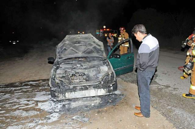 The female driver, without passenger, smelled smoke as she entered the roadway. Shortly after stepping out of the car it burst into flames.