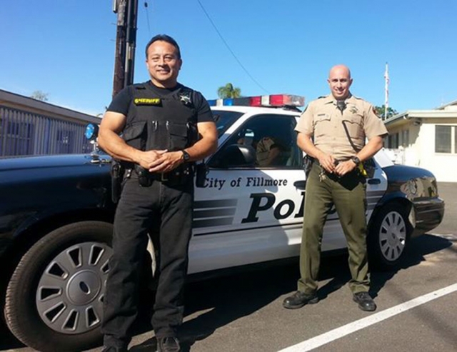Deputies Cesar Salas and Oren Ryerson put ‘To Serve and Protect’ into action, helping a Fillmore family in need. Photo courtesy of Sebastian Ramirez.