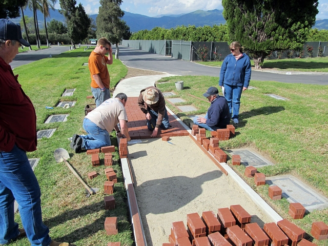 Scouts moved 1300 bricks from the shipping pallets to their final positions on the Walk of Honor last week. They rechecked and smoothed the sand and laid most of the bricks. Sand will be swept in between the bricks and vibrated in to compact and complete the work.