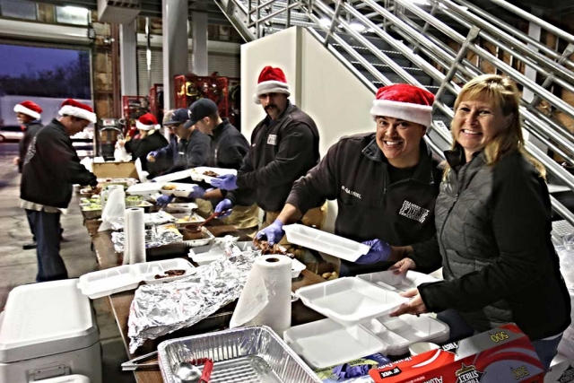 Mayor Diane McCall joins in serving chicken dinners at the Fillmore Fire Station. The fundraiser collects cash and toys towards Christmas gifts for the children of Fillmore.