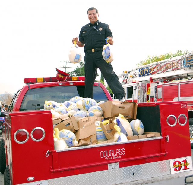 Fire Chief Rigo Landeros was on top of things, handing out 60 turkeys donated by the department.