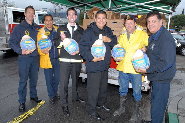 Members of the Fillmore Fire Department and City Attorney Ted Schnieder helped with the turkey give-away at the storefront.