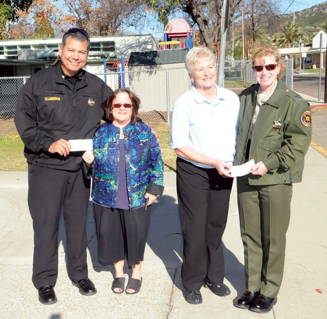 Each year at the San Cayetano Fall Harvest Festival “Grandma” Lou Hoover bakes cinnamon rolls. They sell out immediately and they donate all monies from the cinnamon rolls to charity. The event is sponsored by the Wells Fargo Foundation and we thank our local Wells Fargo manager Eric Iriee for his help in obtaining the yearly funding. We are pleased to be able to give a check to both the Fillmore Fire Department and Fillmore Sheriff’s Department for their annual holiday toy drive. Each check was for $266.25. Pictured (l-r) Fire Capt. Rigo Landeros, San Cayetano Principal Jan Marholin, Grandma Lou Hoover, and Capt. Monica McGrath.