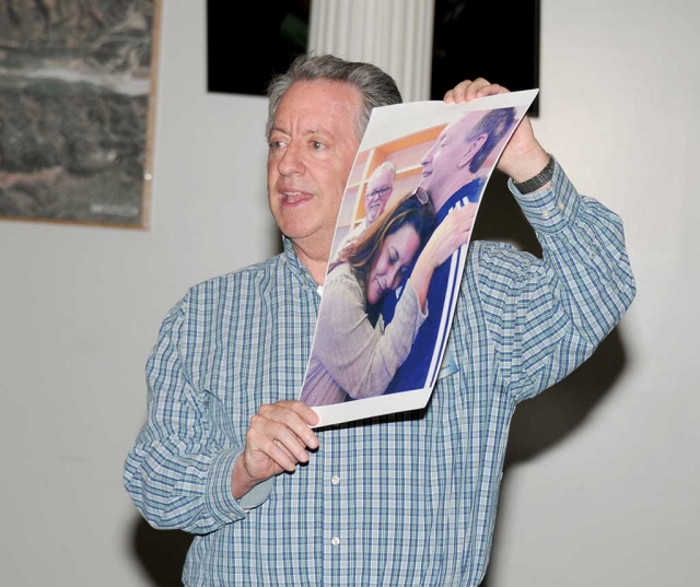 Richard Aidem shows a photo of his heart-donor’s mother listening to her son’s heartbeat, which she does each year during DMV/Donate Life California Month.