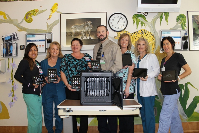 (l-r) Holding iPadsare members of CMH’s pediatric unit, from left, Cynthia Calica, RN; Louise Cowan, RN; Megan Meeke, RN; Dr. Matthew Cameron;  Paula Zajac, RN; Estelle Brutton, RN; and Zahava Weiss, RN.