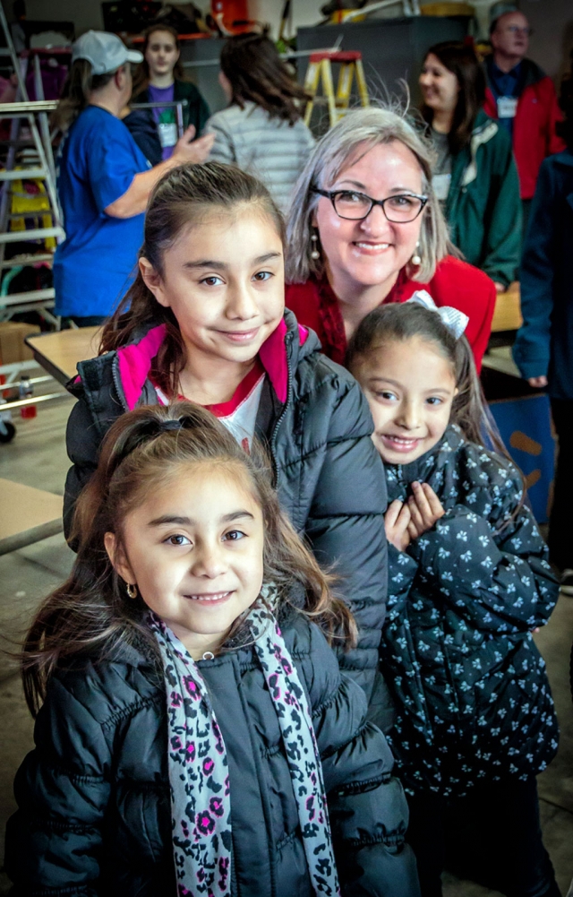 A photo from taken in 2018 of Laura Bartels with three young ladies wearing their new coats. Photo courtesy Bob Crum.