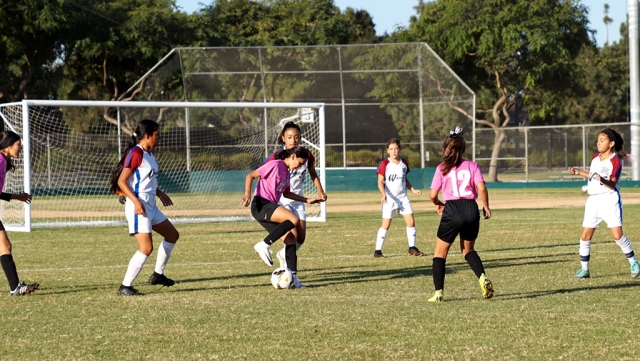 California United’s 2008 Girls Bronze Beta’s #24 Alondra Leon pulls back the ball as she tries to get past the defense, while #12 Leanna Villa tries to help her teammate. Photos courtesy Susan Torres and Erika Arana.
