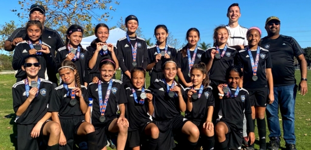 Pictured is the California United FC Silver 2008 Girls-Black team: (l-r) Coaches Jesse Bautista, Miguel Zamora Jr., Ram Kanji: top row (l-r) Valeria Bazaldua, Heidi Zamora, Carla Salcedo, Lizbeth Mendez, Stephanie Mora, Nicole Lopez, Jazleen Vaca, Sydney Nunnery: bottom row (l-r) Serena Montiel, Mia Rodriguez, Olivia Weinerth, Natalia Bautista, Briana Fernandez, Kaya Haddox, Prisha Kanji. Not pictured Umi Agraz. Photo courtesy Nancy Vaca.