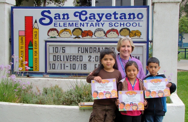 Carol Barringer, guest speaker for the Kinders for the month of October, is shown with our three kinder winners, for the October Peacebuilder Assembly.