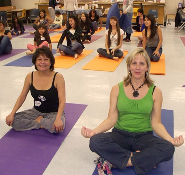 Councilmember Laurie Hernandez and Tammy Hobson enjoy a yoga class at the Empower Yourself with Knowledge retreat on March 16th.
