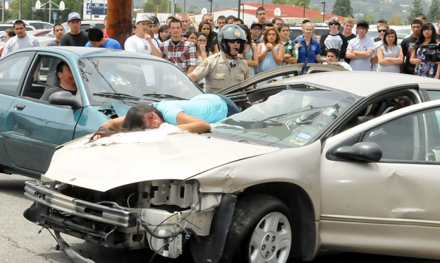 “Every 15 Minutes” is a reinactment of what can happen in the event of drinking and driving. The event was put on by the Fillmore Fire Department and the Ventura County Sheriffs Department. Above, Officer Anthony Biter arrives on scene after the driver of the car calls 911 for help. Students involved in the simulation are (right car) Josephina Hernandez (through windshield), Sergio Cornejo not pictured (driver), in back seat Breanna Vazquez (air-lifted). Left car: driver Jessica Givans, and passenger Brandon Pina.
