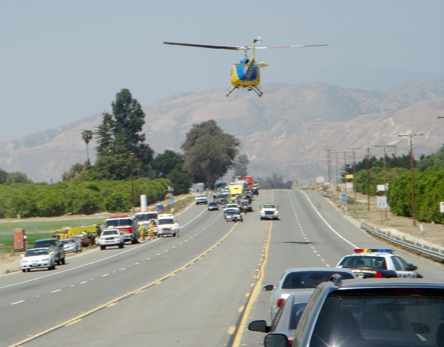 Dorothy Keefe Crosby, 76 of Santa Maria, was killed April 29th in a solo rollover accident. The crash took place near the eastern border of Ventura County, between Piru and the Los Angeles county line. Crosby died of multiple blunt-force trauma. She was driving eastbound at 11:18am, when she lost control of her car. The car landed on its roof (pictured far left parallel to fire engine). Crosby was pronounced dead at the scene. A rescue copter was called in, pictured center. Photo courtesy Henry Negrete.