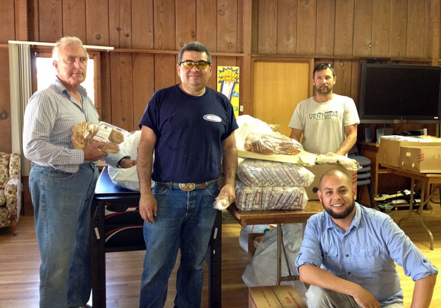 (l-r) Volunteers: Bill Dewey, Edward Barajas, Victor Kreider, Ricardo Miranda, James Doran, who donates his truck every week to pick up the food. Community Food Distribution is sustained through small grants and donations by Trinity Episcopal Church.