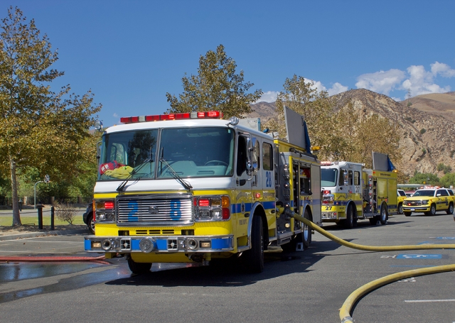 On Wednesday, September 22nd, at 11:57am, Ventura County Fire was dispatched to a small brush fire in the 2400 block of Center Street, Piru. Upon arrival fire crews (ME28) reported several trees on fire by an apartment complex with a light wind blowing towards the residential area. Ventura County Sheriffs were also on scene, and VCFD-VCSO Copter was in the air but was cancelled by ground units as the fire was controlled. There was no threat to the surrounding community. Fire crews requested a fire investigator to respond to the scene. Crews remained on scene for about two hours. Cause of the fire is under investigation. Photos Courtesy Angel Esquivel-AE News.