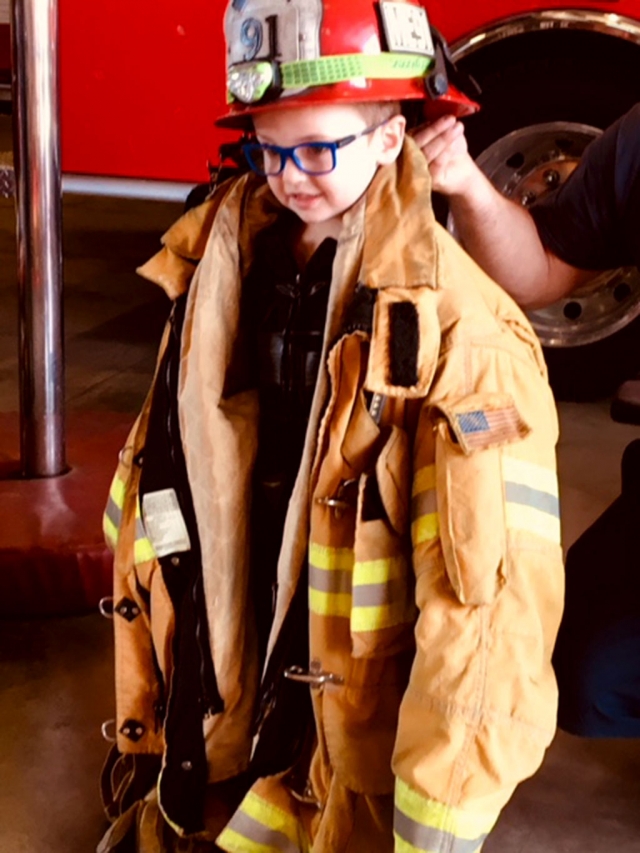 As a special treat for making their donations to the Toy Drive the students were able to try on the fire fighter’s uniforms.