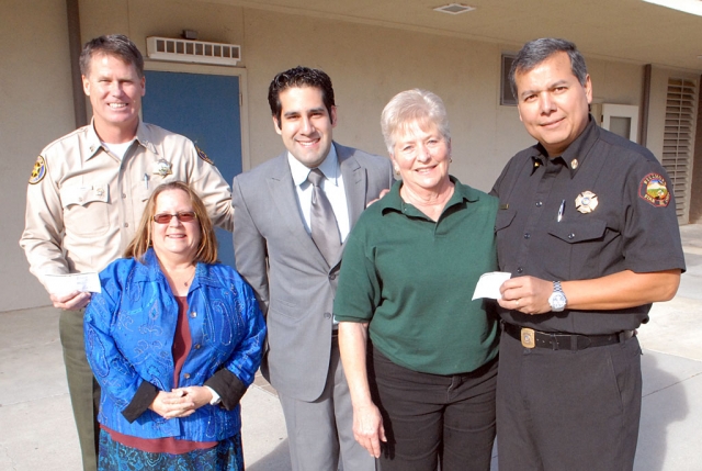 Wells Fargo Foundation has annually sponsored the Fall Harvest Festival/Carnival for the elementary schools of Fillmore and Piru. Each year Louella Hoover Cafeteria Manager from Sespe School, volunteers her time to make her famous cinnamon rolls.  There is always a waiting line for the rolls and they sell out quickly. The money generated from the cinnamon roll sales are donated to a local charity. This year the Fillmore Sheriffs and Fire Department are the recipients of the funds--$209 each. They will be used for the local holiday toy drives. Pictured here are Capt. Tim Hagle, San Cayetano Principal, Jan Marholin, Wells Fargo Branch Manager Billy Ramirez, Grandma Lou from  Sespe School and Capt. Rigo Landeros . Happy Holidays!