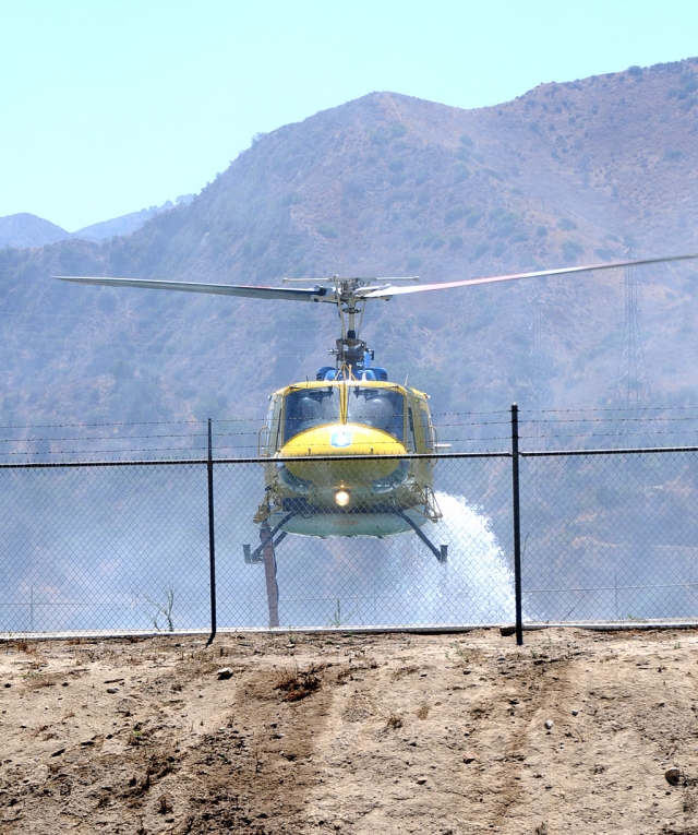 What started as a 10-acre consuming fire, spread to 90 last Sunday, starting at 9:15am. 49 fire units were called in to attack the fire, located north of Highway 126 at Old Telegraph Road and La Falda Way, east of Piru. Approximately 125 firefighters battled the flames, which traveled northeast up steep canyon walls towards a ridgeline covered in light brush. Units came from Ventura and Los Angeles counties, with Los Padres National Forest hand crews and CalFire also responding. Fire retardant was dropped form fixed-wing aircraft, and bulldozers and helicopters joined in to build containment lines and drop water lifted from a reservoir off the highway (above). The fire was contained by 5pm, Sunday.