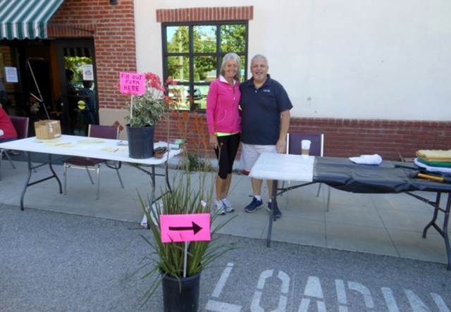 Flower show volunteers, Moe Shea and Mark Ortega, set up stations for entries.