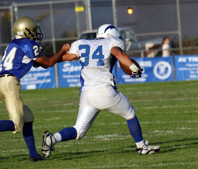 Sammy Orozco #34 runs the ball for yardage against Channel Islands. Orozco scored two touchdowns and accumulated 150 yards. Fillmore lost 34-14.