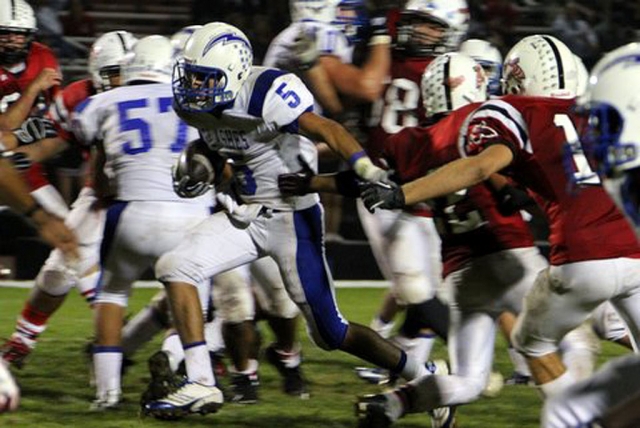 Tyler Esquivel # 5 runs the ball for a few yards.