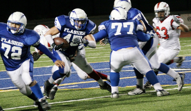 Above Jose Rangel #72, Gabriel Gomez #77 open the path up for Matt De La Cruz #45 to run the ball in the fourth quarter.