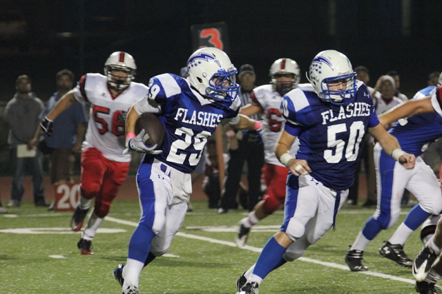 Mario Hernandez #29 runs the ball for a few yards.