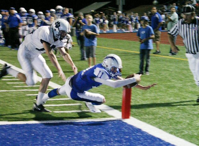 Corey Cole dives into the end zone for one of his three touchdowns. Cole also had 3 passes for 83 yards.