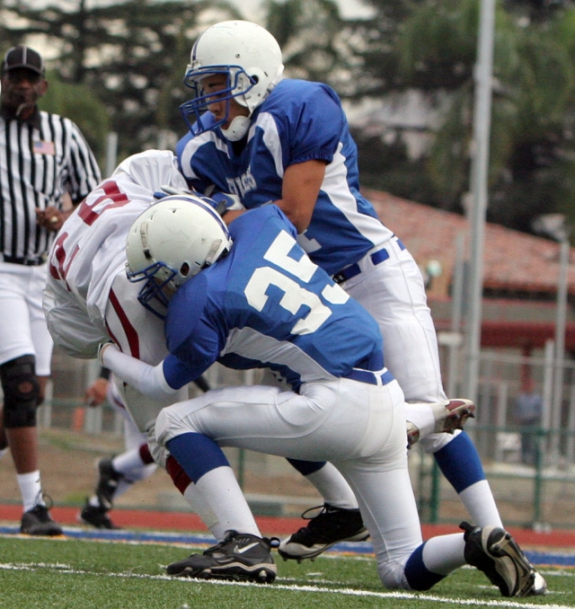 Jordan Davis #34 and Christian Conaway #35 stop Santa Paula.