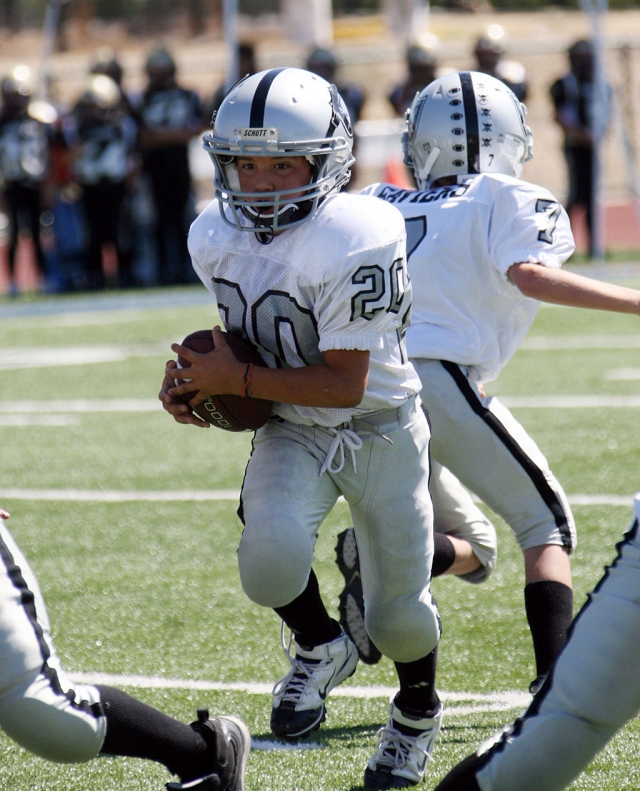 #20, Fillmore Raiders’ Bantam team, runs the ball for a few yards at last Saturday’s game.