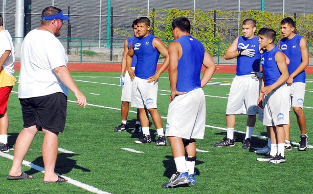 Coach Dollar talks to the players before the next play.