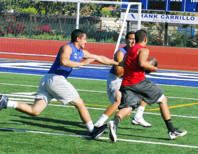 Sammy Orozco and Chris De La Paz make contact with the receiver before he scores.