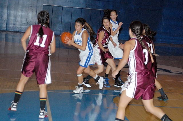 Above & below: Ashely Coert #5 attempts to make a three point shot against Santa Paula, last Friday, December 3rd. Also pictured Kayla Grove #4. The Fillmore Lady Flashes had an exciting tournament this past week. The teams involved in the tournament included LA Baptist, San Marcos, Bishop Diego, Santa Paula, Rosamond, Thacher, La Reina and Fillmore. Our Lady Flashes finished with two wins and two losses. Our team is young this year, there are no seniors on the team. The team members include juniors Jaynessa Lopez and Jenna Wilber, the only two returning varsity members from last year. New to the varsity team this year are juniors Ashley Coert, Esperanza Ocegueda and Ana Morino, sophomores Briana Garcia and Mary Ortiz and freshmen Kayla Grove, Raquel Aguilar and Anissa Cabral. Our All Tournament player was freshman Raquel Aguilar with a total of 47 points throughout the tournament and 25 rebounds. Our next tournament will begin Wednesday December 8th at Laguna Blanca in Santa Barbara and continue through Saturday.