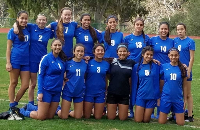 Flashes Girls JV and Varsity Girls Soccer teams celebrate with a photo after defeating Thatcher.