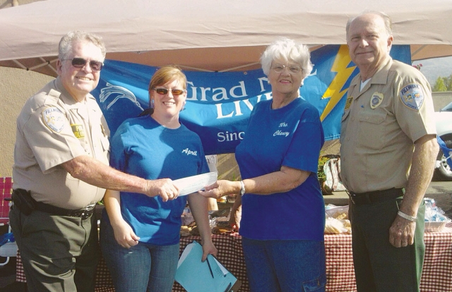 Friday, May 11, Fillmore Citizens Patrol presented Grad Nite Live a check for $1000, to go towards the graduation cruise. Pictured (l-r) Steve Hope, April Hastings, Raelene Chaney, and John Harm.