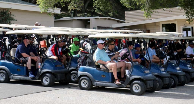 Golfers sit in their carts waiting to get on the green for the 3rd Annual Chief Rigo Landeros Memorial Golf Tournament.