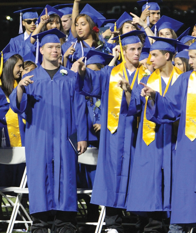 Graduates singing the Alma Mater at the end of the ceremony.
