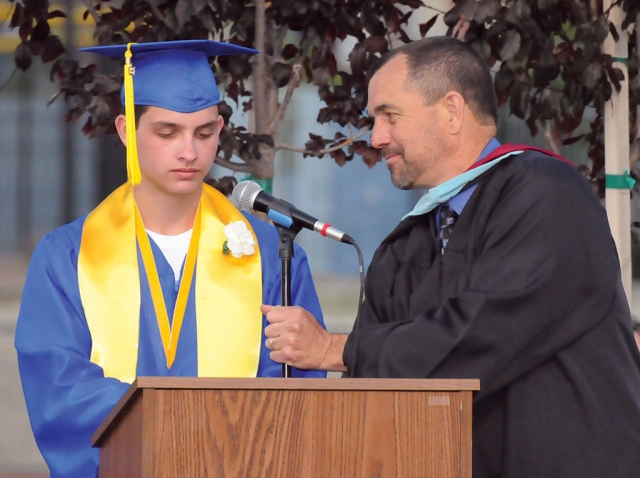 Class Valedictorian Troy Spencer prepares to read his speech to the audience.