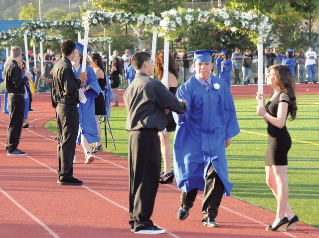 Graduates walked beneath the arches.
