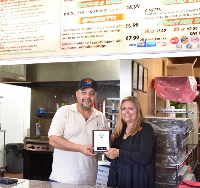 Both FZ Tax Services and Portobello Pizza are members of the Fillmore Chamber of Commerce. (l-r) Bernardino Orea from Portobello Pizza and Ari Larson from the Fillmore Chamber of Commerce, presenting the business with a membership plaque