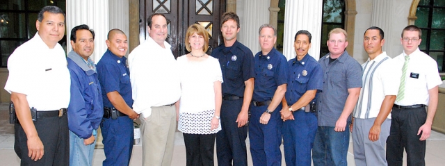 Pictured above (l-r) Fire Chief Rigo Landeros, Robert Reyes, Billy Gabriel, Scott and Season McClusky, parents of the jogger who suffered a heart attack, Rick Houston, Bob Thompson, Al Huerta, David Brown, Jose Mendez, and Benjamin Pratt. Not pictured Martin Lopez. Lopez was also recognized for his assistants in the emergency.