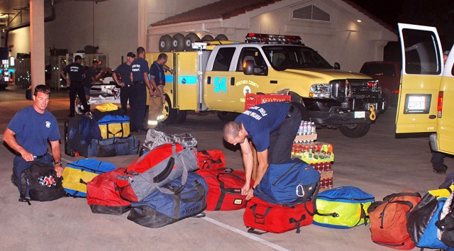 Firefighters assembled all the gear they might need prior to loading it into the vehicles.