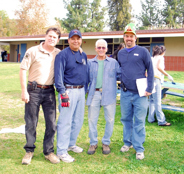 Over 175 motivated volunteers converged on the Fillmore High School campus last Saturday morning to work on a number of cleanup and beautification projects.  Projects included rose pruning and fertilization, mulching, raking leaves, sweeping, weeding, shrub pruning, painting of lunch tables, library cleaning and straightening, and sidewalk gum removal.  The event was co-hosted by Fillmore High School, the Big Brothers-Big Sisters Mentor Program, the Fillmore Lions Club and the Fillmore Morning Rotary Club.  It was a great example of collaboration between school and community groups. 