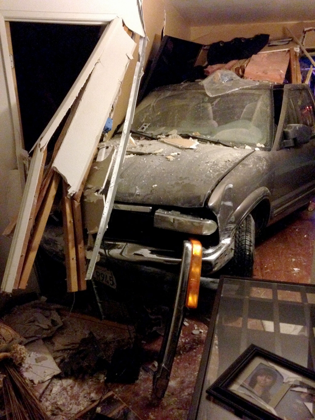 A Chevy Blazer crashed through a picket fence, knocked down a mailbox and landed in the middle of a livingroom in a house located in the 700 Block of B Street. Driver Milka Catalan Ramirez, 26 of Fillmore, was cited and released at the scene for being an unlicensed driver. No evidence of alcohol or drugs was reported. It is considered a distracted driving incident. Fillmore Fire responded to stabilize the residence for the removal of the vehicle, and shut off all utilities. No injuries were reported. The incident occured at 5:55am, Tuesday morning, April 1st. Significant structural damage was done to the home. Photos courtesy Fillmore Fire.