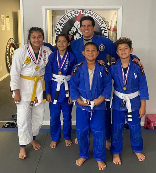 (l-r) Fillmore Youth Brazilian Jiujitsu practitioners Emma Torres, Audrina Alba, Coach Michael Torres, Danny Martinez, and Cris Martine who competed at the Gracie Humaita Jiujitsu Tournament.