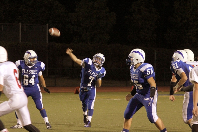J.V. #7 Hector Sanchez throws a first down pass while being protected by #64 Angel Medina and #55 Michael Morris