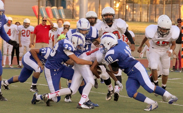 J.V. #33 Ruben Rosales and #10 Daniel Tafoya stop the run